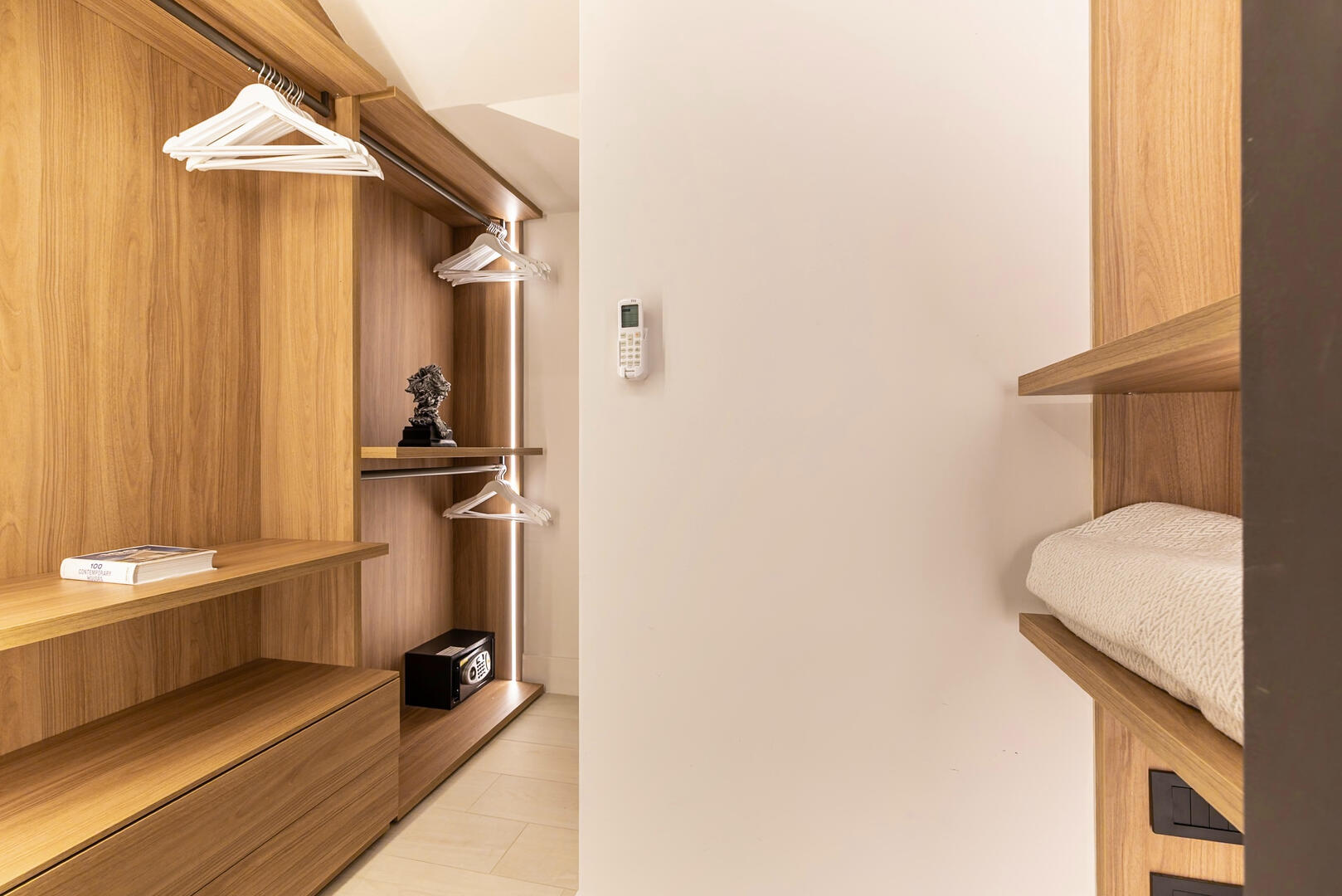 Organized walk-in closet with generous storage and lighting.